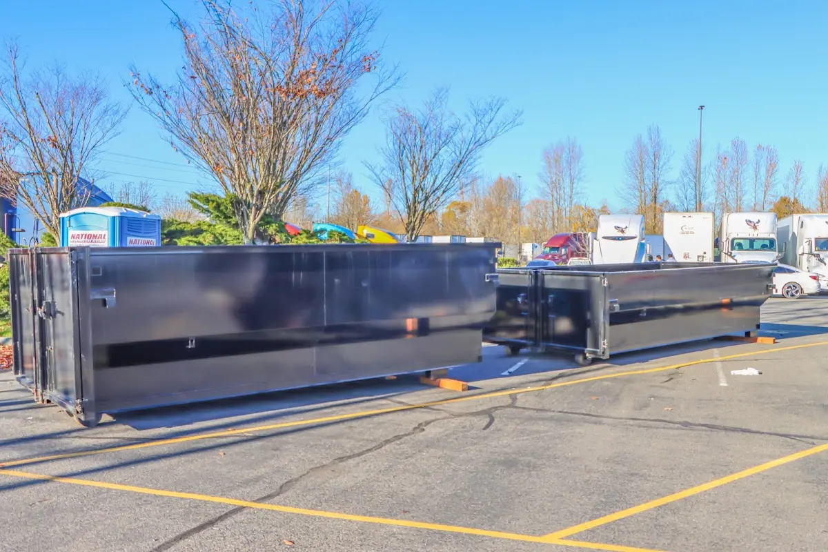 Professional dumpster rental service with roll-off container on residential driveway in Larose